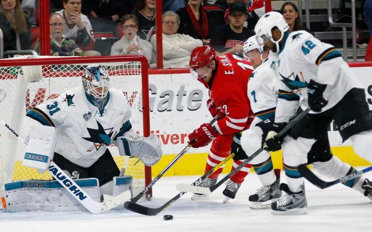 Eric Staal works against San Jose’s Martin Jones (31), Paul Martin (7) and Joel Ward (42) during the Hurricanes’ 5-2 win over the Sharks on Feb. 19.