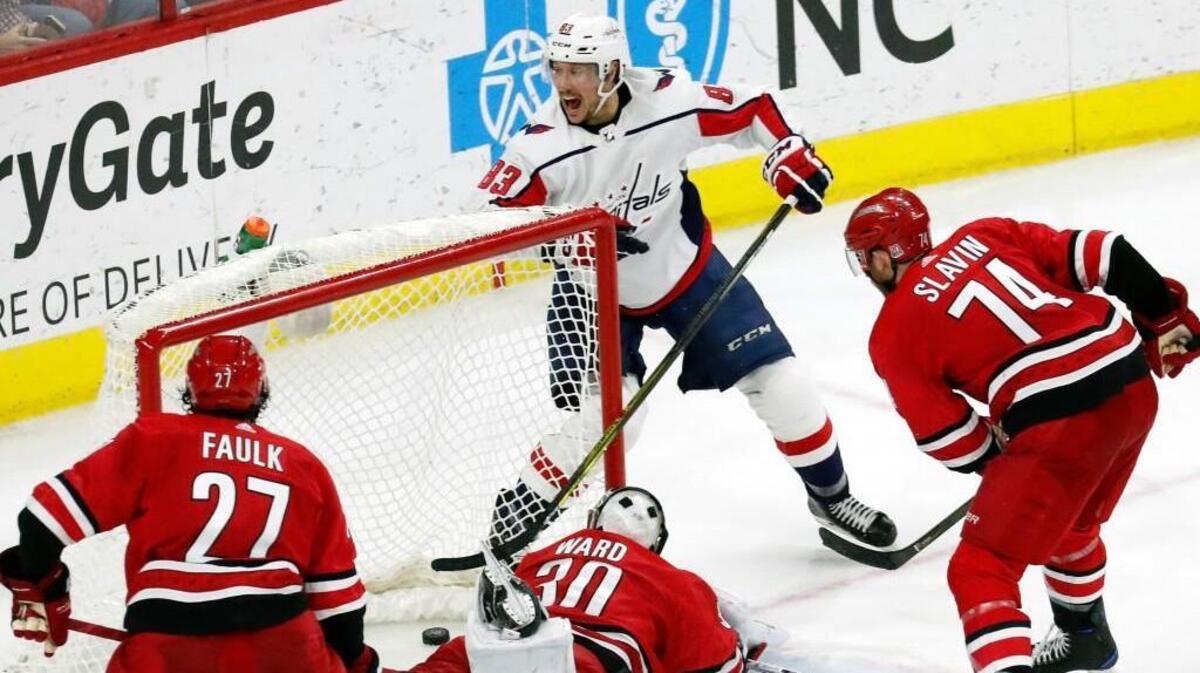 The Caps' Jay Beagle (83) celebrates his winning shot in the final seconds during the third period an NHL game played between the Carolina Hurricanes and the Washington Capitals at PNC Arena in Raleigh, N.C. on Jan. 12, 2018. The Canes' Justin Faulk (27), Cam Ward (30) and Jaccob Slavin (74) look on. The Caps beat the Canes 4-3.