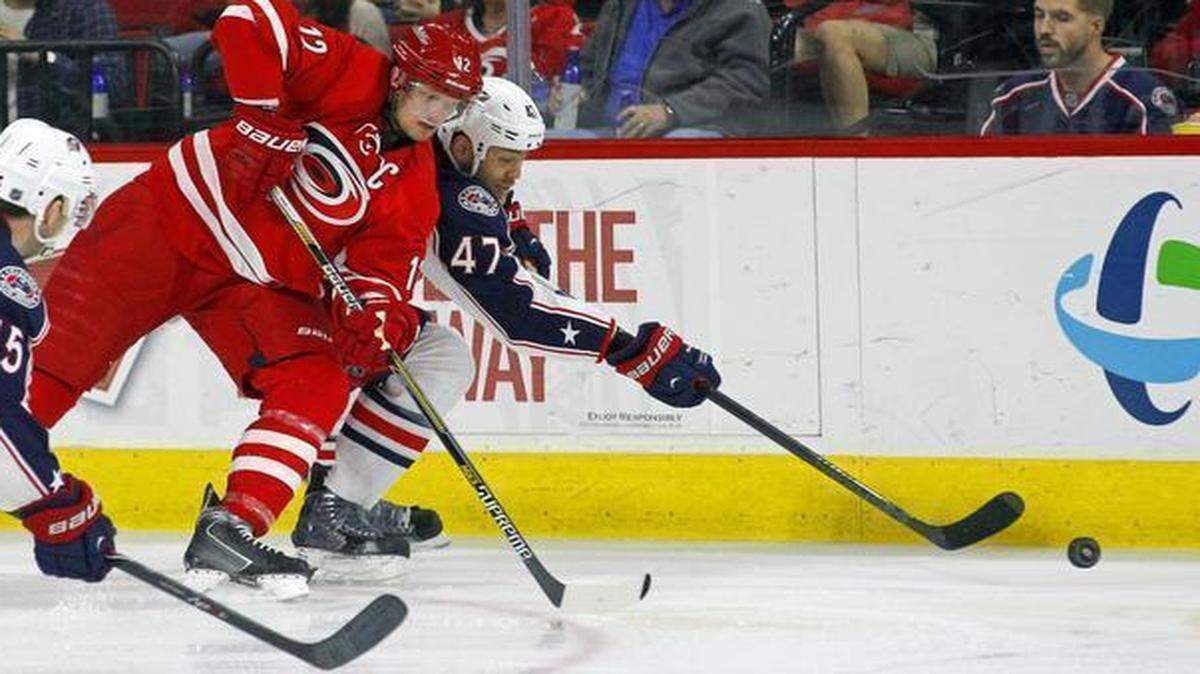 
The Canes Eric Staal (12) battles the Columbus Blue Jackets' Mark Letestu (55) and Dalton Prout (47) for the puck during the second period of an NHL game played between the Carolina Hurricanes and the Columbus Blue Jackets at PNC Arena in Raleigh, N.C. on March 10, 2015.
