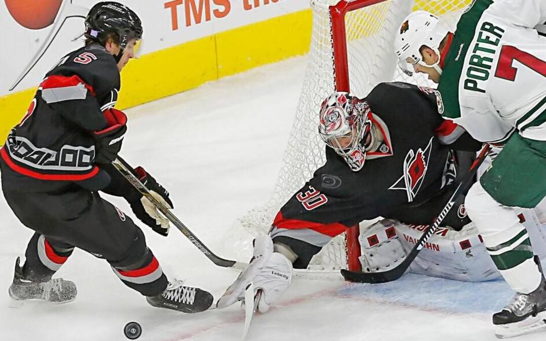The Canes Noah Hanifin (5) and Cam Ward (30) defend against the Wild's Chris Porter (7) during the third period of an NHL game played between the Carolina Hurricanes and the Minnesota Wild at PNC Arena in Raleigh, N.C. on Nov. 12, 2015. The Wild beat the Canes 3-2 in overtime.