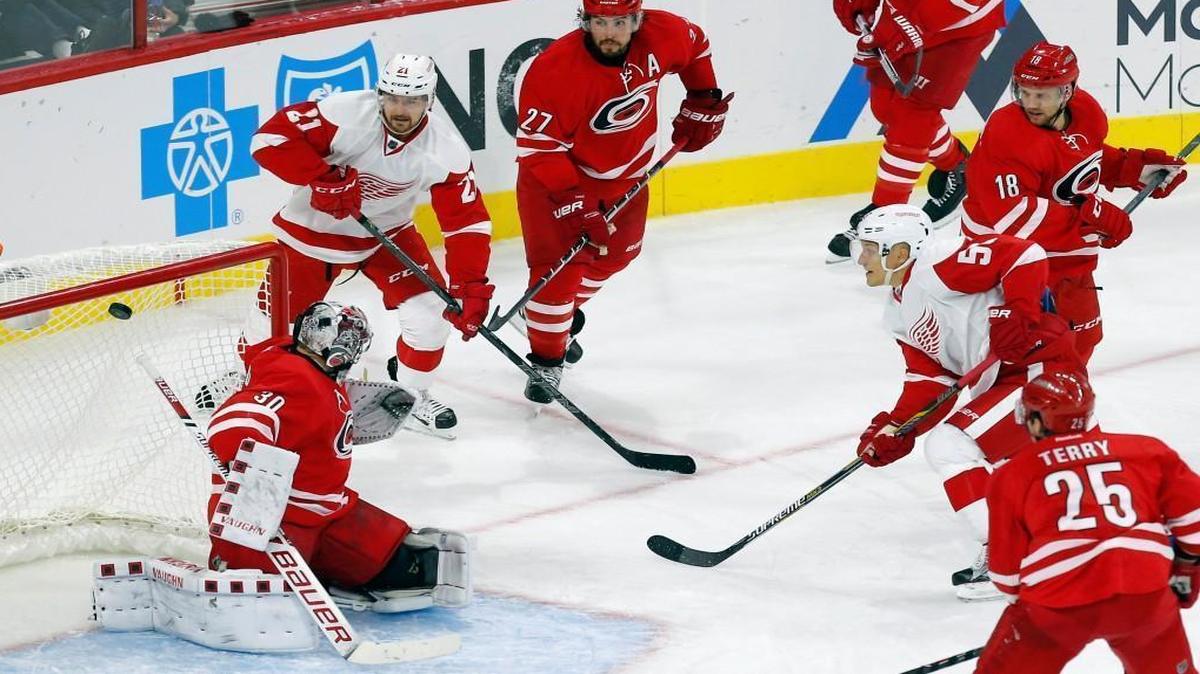 
The Detroit Red Wings' Teemu Pulkkinen (56) puts the puck past the Carolina Hurricanes' Cam Ward (30) for a goal during the third period at PNC Arena in Raleigh. The Detroit Red Wings' Tomas Tatar (21) and the Canes Justin Faulk (27), Jay McClement (18) and Chris Terry (25) look on. The Red Wings beat the Canes 4-3.
