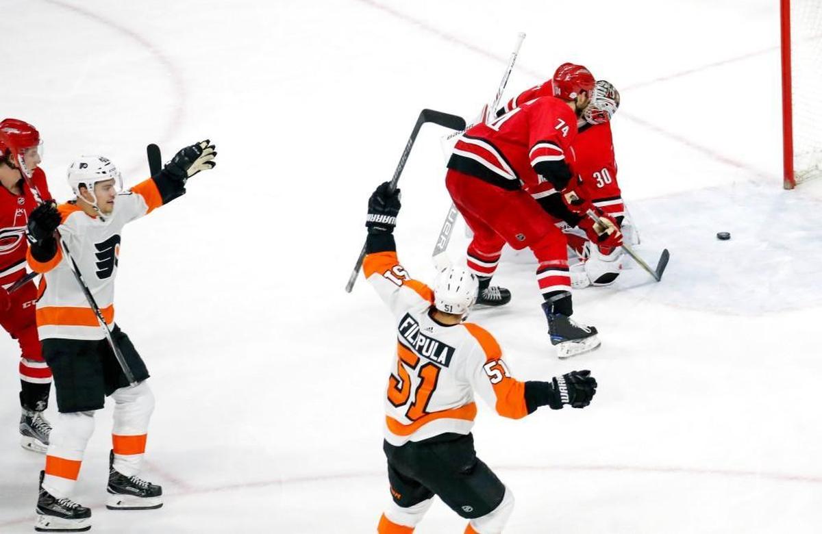 The Flyers' Jordan Weal (40) celebrates his game winning goal with Valtteri Filppula (51) after he scored against the Canes' Brock McGinn (23), Jaccob Slavin (74) and Cam Ward (30) in the final seconds of the overtime period in an NHL game played between the Carolina Hurricanes and the Philadelphia Flyers at PNC Arena in Raleigh, N.C. on Feb. 6, 2018. The Flyers beat the Canes 2-1 in overtime.