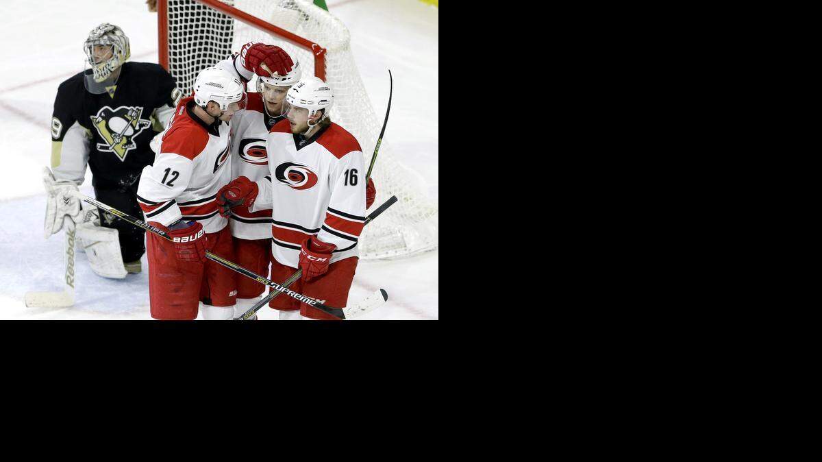 
Carolina Hurricanes' Eric Staal (12), Andrej Nestrasil, center, of the Czech Republic, and Elias Lindholm (16), of Sweden, celebrate Nestrasil's goal against Pittsburgh Penguins goalie Marc-Andre Fleury during the third period of an NHL hockey game in Raleigh, N.C., Thursday, March 26, 2015. Carolina won 5-2. 
