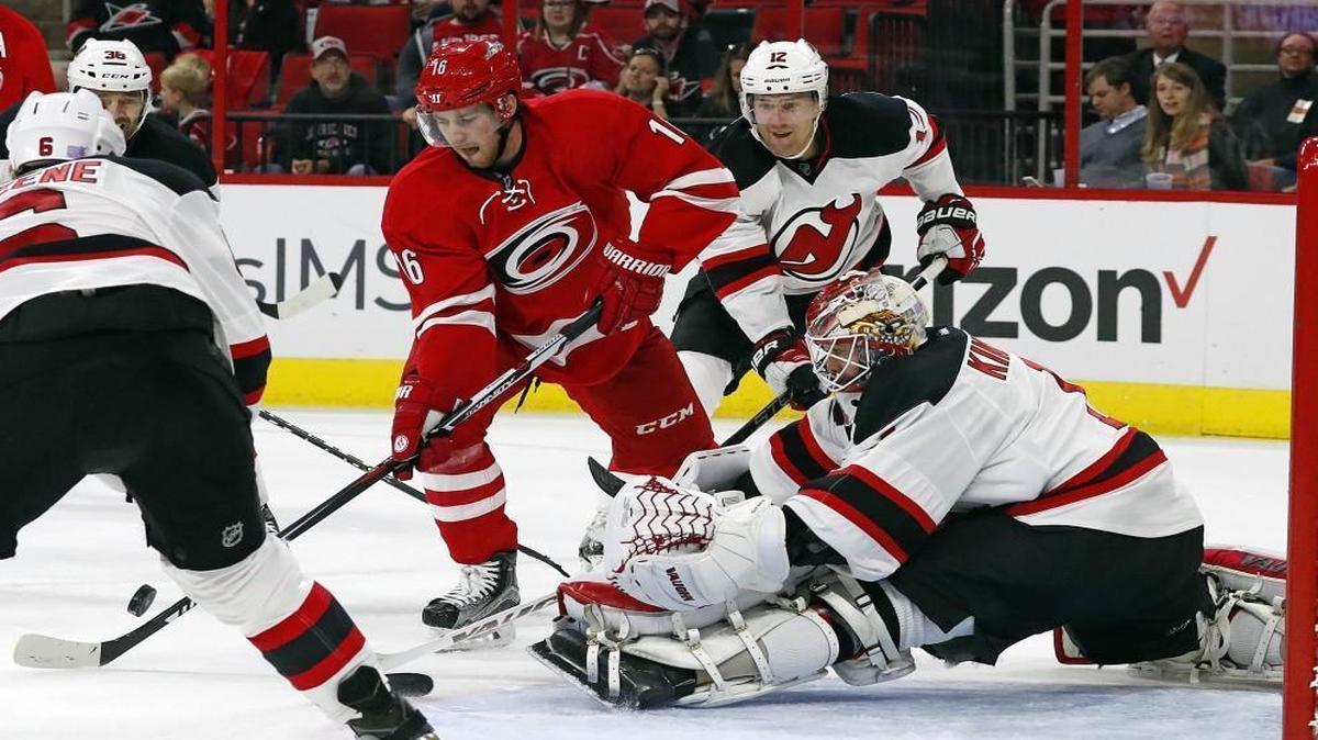 Carolina Hurricanes' Elias Lindholm (16) has his shot blocked by New Jersey Devils goalie Keith Kinkaid during the second period.