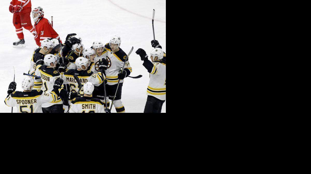 
The Bruins’ David Pastrnak (88) is mobbed by his teammates after he scored the winning goal in the overtime period to beat the Carolina Hurricanes 2-1 at PNC Arena in Raleigh.
