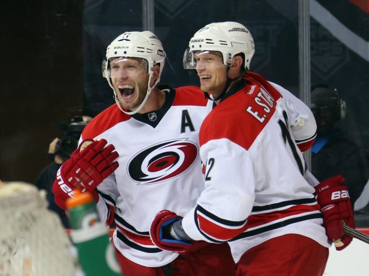 Carolina Hurricanes Jordan Staal (11) and Eric Staal (12) of the Carolina Hurricanes celebrate the game-tying goal by Chris Terry at 14:56 of the third period against the New York Islanders at the Barclays Center.