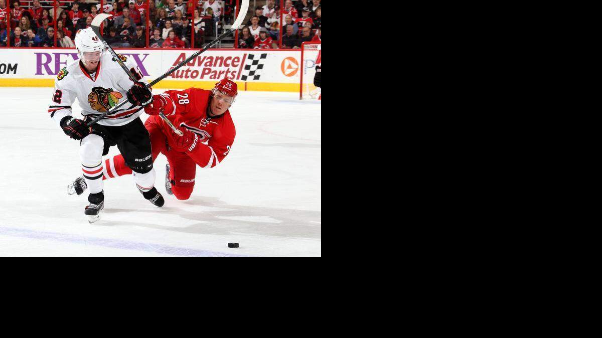 
Alexander Semin #28 of the Carolina Hurricanes goes down while battling for the puck with Joakim Nordstrom #42 of the Chicago Blackhawks during their NHL game at PNC Arena on March 23, 2015 in Raleigh, North Carolina.
