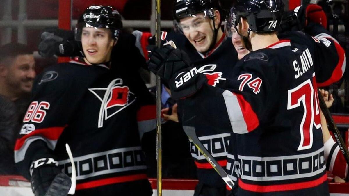 The Canes' Brett Pesce celebrates his goal with Brock McGinn, left, Teuvo Teravainen, center right, and Jaccob Slavin, right, during game against the New York Islanders at PNC Arena on Jan. 14, 2017.