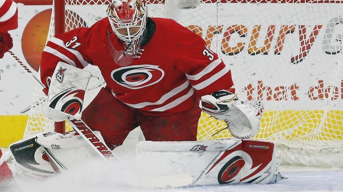 The Canes’ Eddie Lack (31) minds the net during the first period of an NHL game played between the Carolina Hurricanes and the New Jersey Devils at PNC Arena.