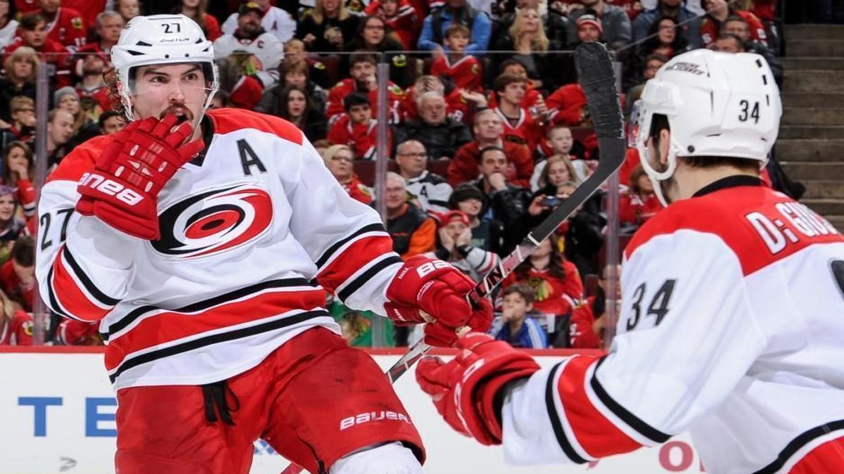 Justin Faulk, left, of the Hurricanes reacts after scoring against the Blackhawks in the second period in Chicago.
