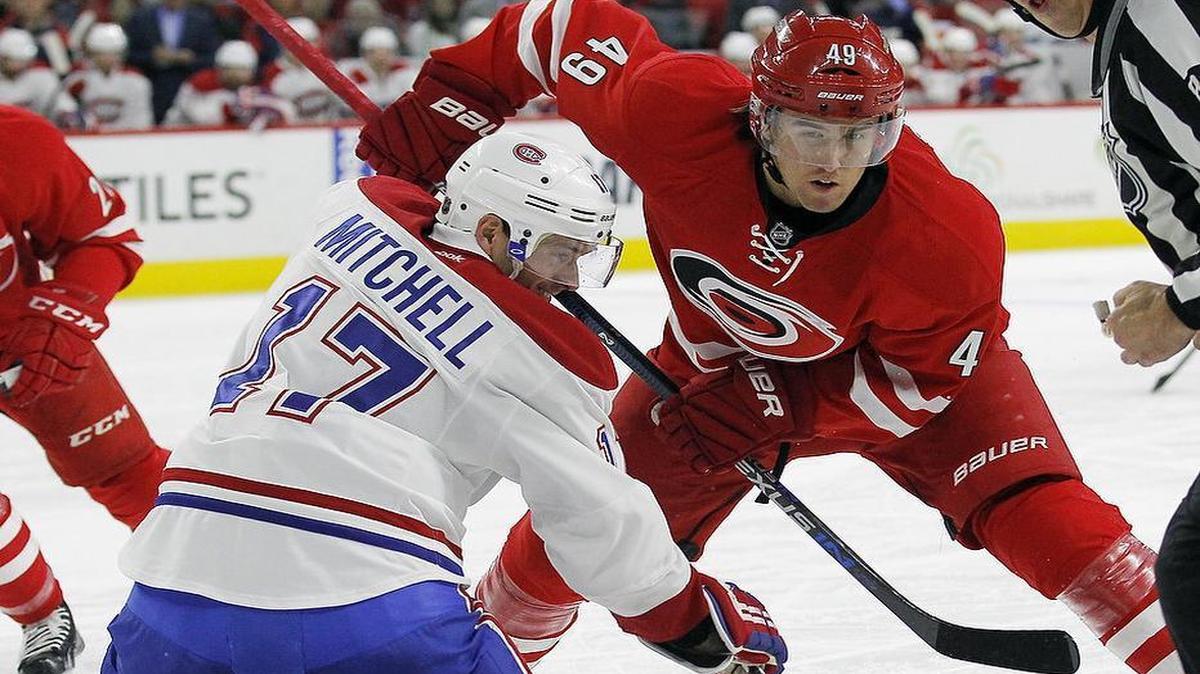 The Canes Victor Rask (49) faces off against the Canadiens Torrey Mitchell (17) during the first period.