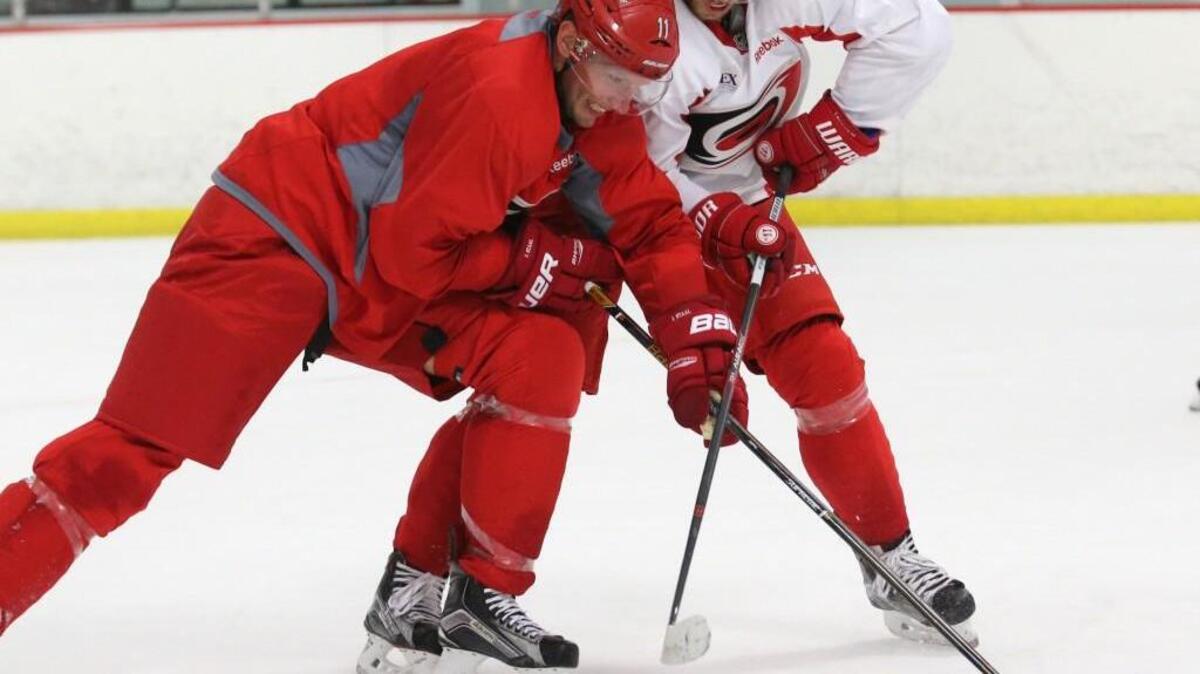 Jordan Staal, left, and Elias Lindholm battle for the puck as some of the Hurricanes hold an informal workout at Raleigh Center Ice on September 14, 2016.
