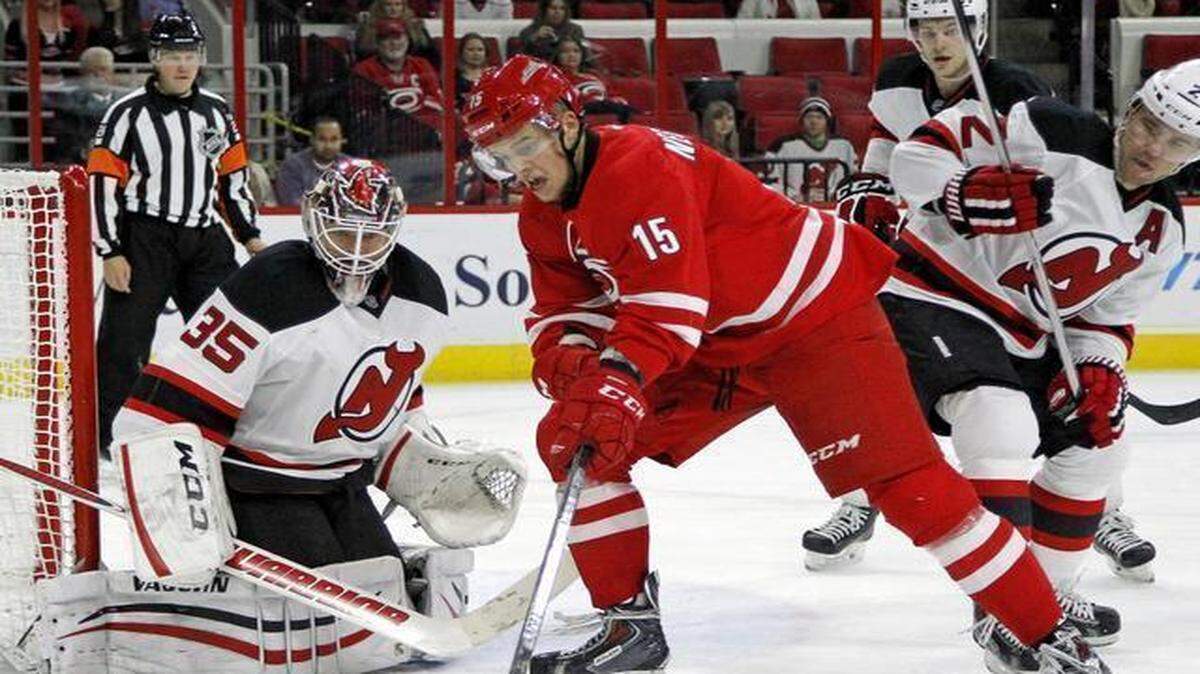 
The Canes Andrej Nestrasil works against the Devils Cory Schneider (35) and Marek Zidlicky (2) during a game between the Carolina Hurricanes and the New Jersey Devils at the PNC Arena in Raleigh, N.C., on Dec. 8, 2014. 
