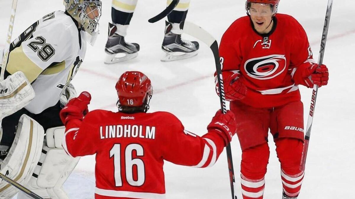 The Carolina Hurricanes' Jeff Skinner (53) celebrates his winning goal with Elias Lindholm (16) after scoring against the Pittsburgh Penguins' Marc-Andre Fleury (29) during the overtime period of an NHL game played between the Carolina Hurricanes and the Pittsburgh Penguins at the PNC Arena Tuesday.