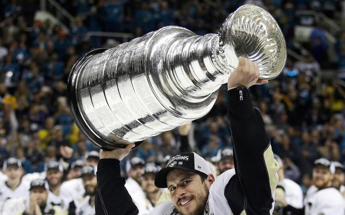 In this June 12, 2016, Pittsburgh Penguins center Sidney Crosby raises the Stanley Cup after Game 6 of the NHL hockey Stanley Cup Finals against the San Jose Sharks in San Jose, Calif. A repeat Stanley Cup champion hasn't happened in the league since the Red Wings in 1997 and 1998.