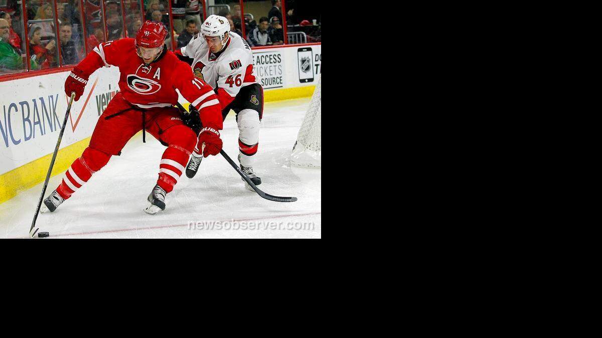 
The Canes' Jordan Staal (11) and the Ottawa Senators' Patrick Wiercioch (46) go for the puck during the first period.
