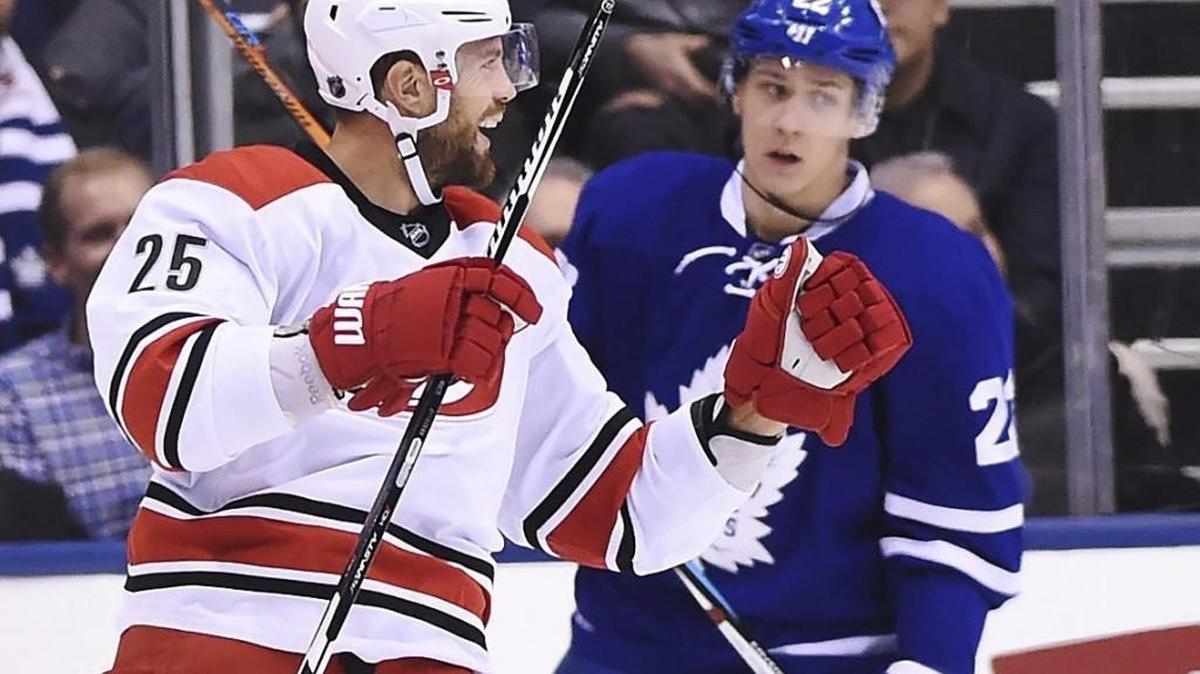 Carolina Hurricanes’ Viktor Stalberg (25) celebrates his goal as Toronto Maple Leafs’ Nikita Zaitsev (22) skates nearby during the second period of an NHL hockey game in Toronto on Tuesday, Nov. 22, 2016.