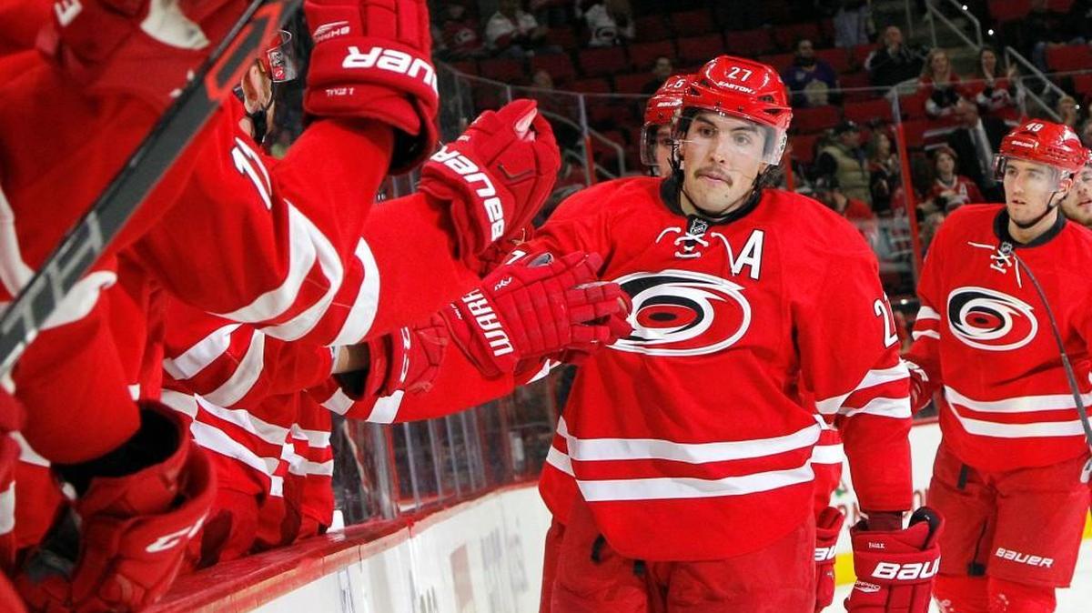The Canes’ Justin Faulk (27) is congratulated by his teammates as he skates back to the bench after he scored during the second period of an NHL game played between the Carolina Hurricanes and the Los Angeles Kings at PNC Arena in Raleigh, N.C. on Nov. 22, 2015. The Canes beat the Kings 4-3.