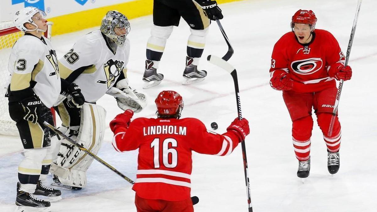 The Carolina Hurricanes' Jeff Skinner (53) celebrates his winning goal with Elias Lindholm (16) after scoring against the Pittsburgh Penguins' Olli Maatta (3), Marc-Andre Fleury (29) and Eric Fehr (16) during the overtime period at the PNC Arena in Raleigh.