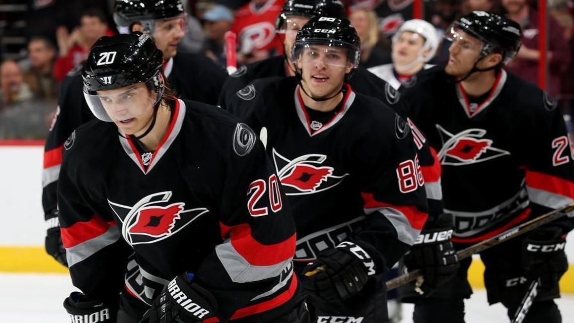Carolina Hurricane Sebastian Aho (20) skates to the bench with teammates after scoring his first NHL goal during game against the Washington Capitals.