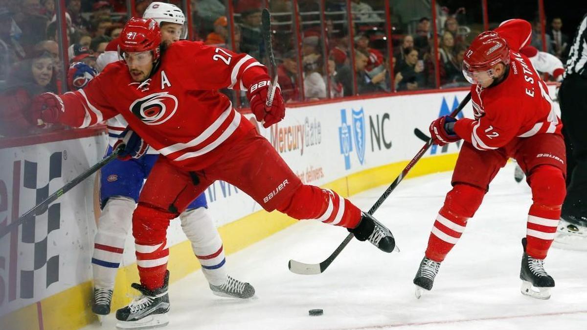 The Carolina Hurricanes' Justin Faulk (27) and Eric Staal (12) battle the Montreal Canadiens' Brian Flynn (32) during the first period of an NHL game played between the Carolina Hurricanes and the Montreal Canadiens at PNC Arena on Dec. 5.