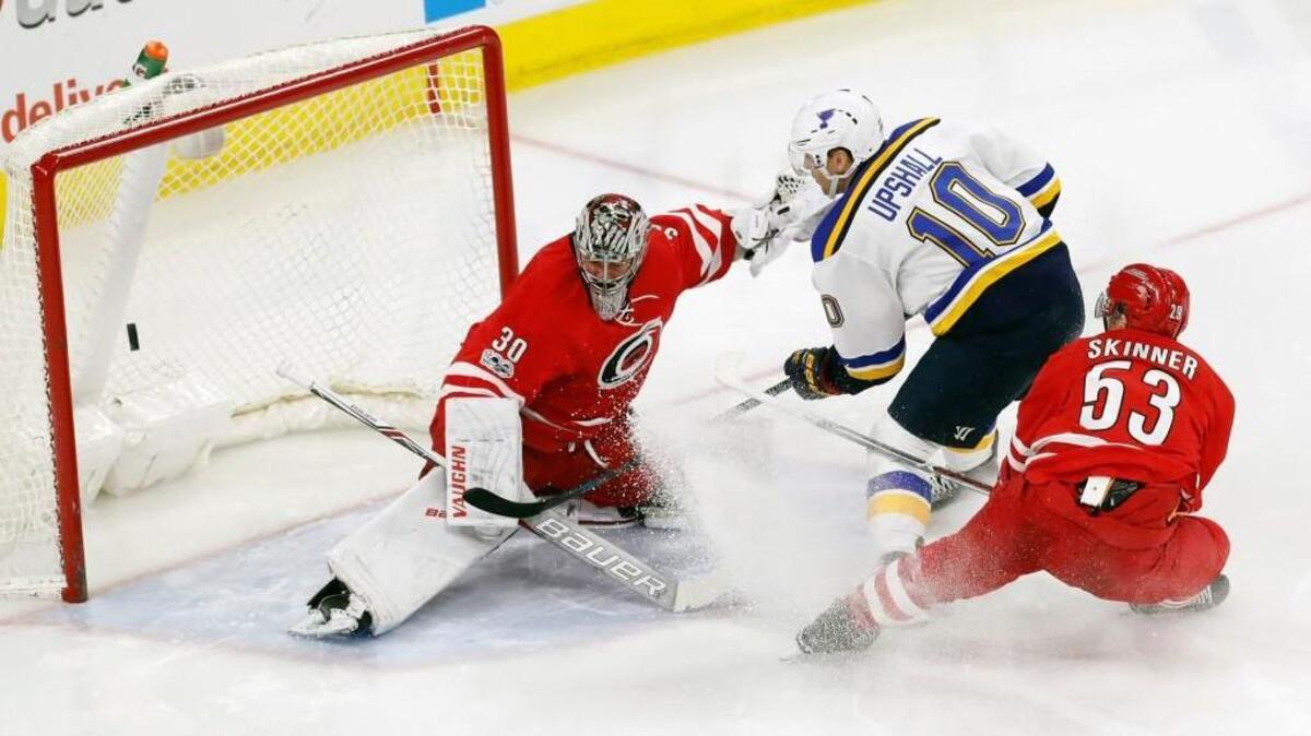 The St. Louis Blues' Scottie Upshall (10) scores a goal against the Canes' Jeff Skinner (53) and Cam Ward (30) at PNC Arena on April 8, 2017.