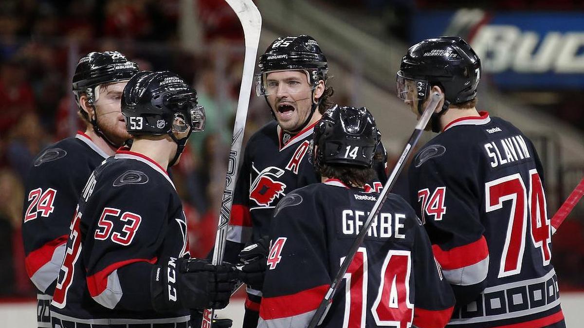 The Carolina Hurricanes' Ron Hainsey (65) celebrates his goal with Brad Malone (24), Jeff Skinner (53), Nathan Gerbe (14) and Jaccob Slavin (74) during the first period.