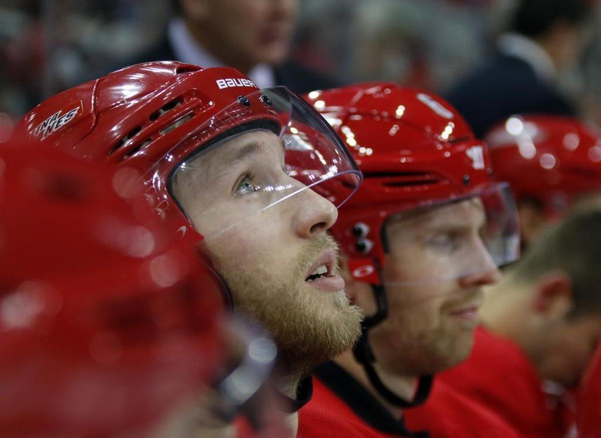 The Canes' Jaccob Slavin (74) takes a break on the bench during game against the Anaheim Ducks at PNC Arena on Nov. 10, 2016.