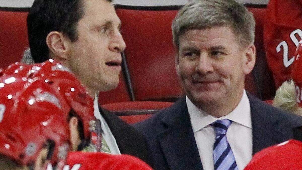The Canes head coach Bill Peters, right, flashes a smile at assistant coach Rod Brind'Amour.