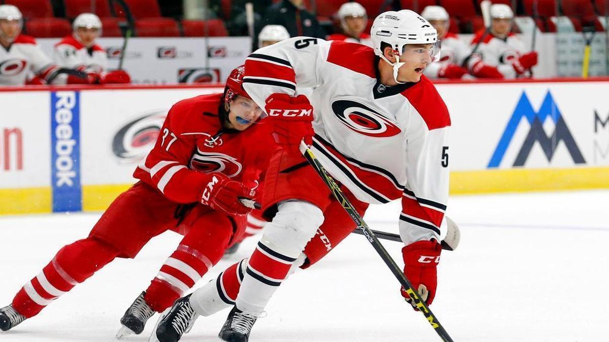 
Noah Hanifin (5) moves the puck against Warren Foegele (37) as the Carolina Hurricanes hold a training camp for NHL prospects at PNC Arena in Raleigh on July 7, 2015. Hanifin was the Canes 2015 first-round draft pick.
