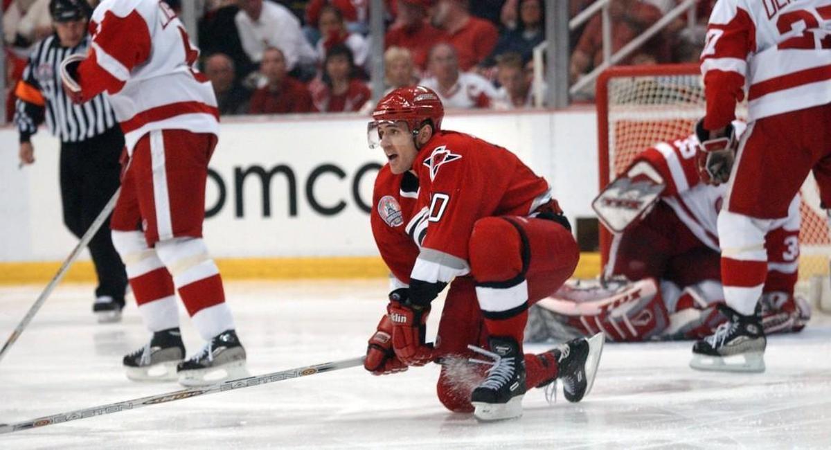 Carolina Hurricanes (10) Ron Francis turns to celebrate his game winning goal in overtime on Detroit goalie (39) Dominik Hasek to give the Hurricanes a 3-2 victory on May 4, 2002 in the first game of the Stanley Cup Championship series at Joe Louis Arena.