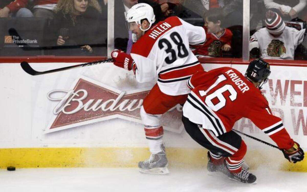 
Carolina Hurricanes defenseman Jack Hillen fights for the puck with Chicago’s Marcus Kruger during the third period of their game on Monday in Chicago. 
