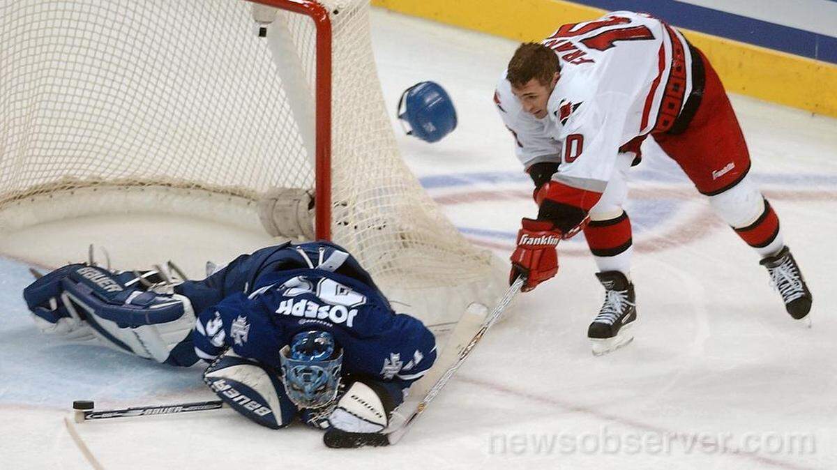 Carolina Hurricanes (17) Ron Francis looses his helmet as he tries to score on Toronto goalie (31) Curtis Joseph during a 2002 game.