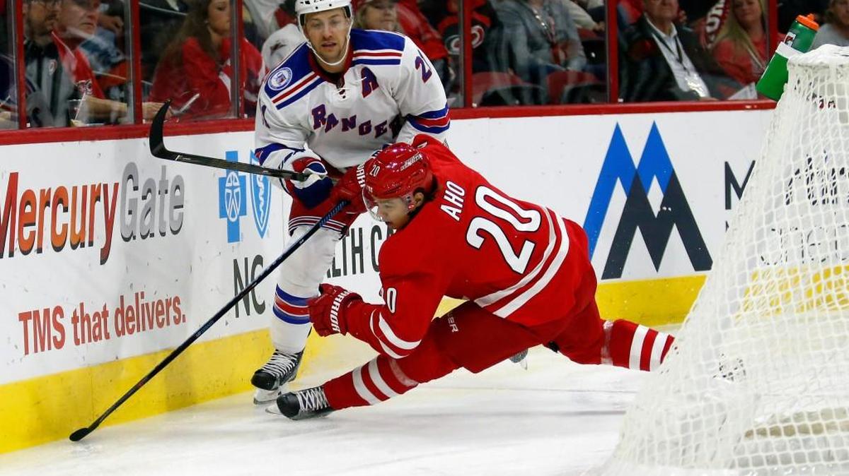The Carolina Hurricanes' Sebastian Aho (20) battles against the New York Rangers' Derek Stepan (21) during the first period of an NHL game played between the Carolina Hurricanes and the New York Rangers at PNC Arena in Raleigh, N.C. on Oct. 28, 2016.