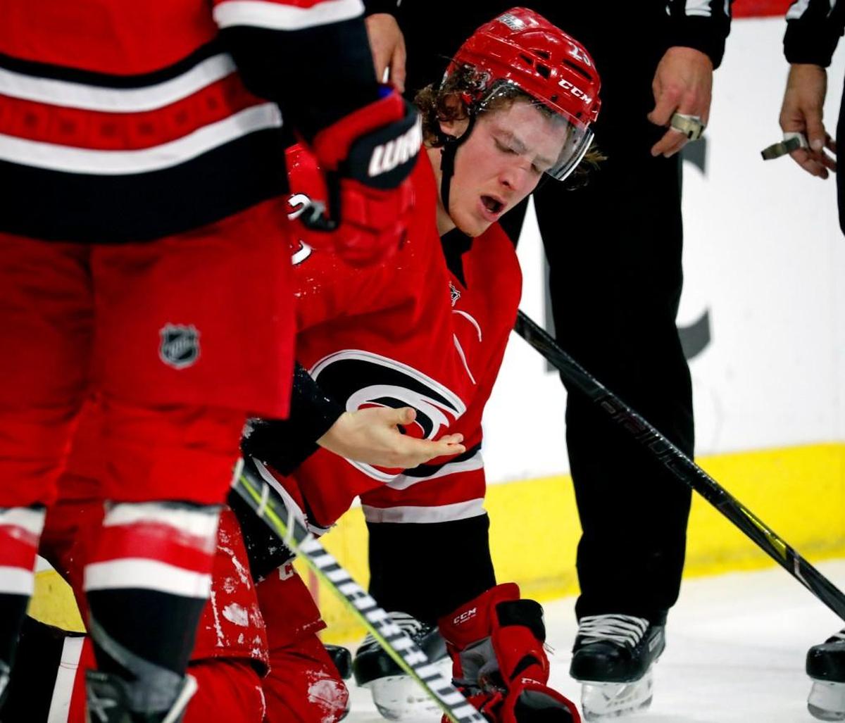 The Canes' Brock McGinn (23) looks at the blood on his hand after he was hit by the Flyers' Nolan Patrick (19) during the first period. Nolan was given a double minor penalty on the play. The Canes scored on that power play.