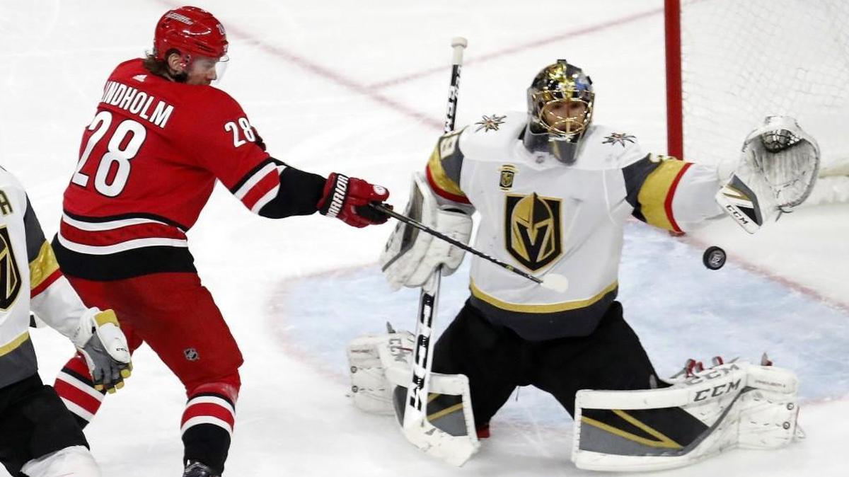 The Hurricanes' Elias Lindholm, left, can't get the puck past Golden Knights goalie Marc-Andre Fleury on Sunday. The Golden Knights beat the Canes 5-1.