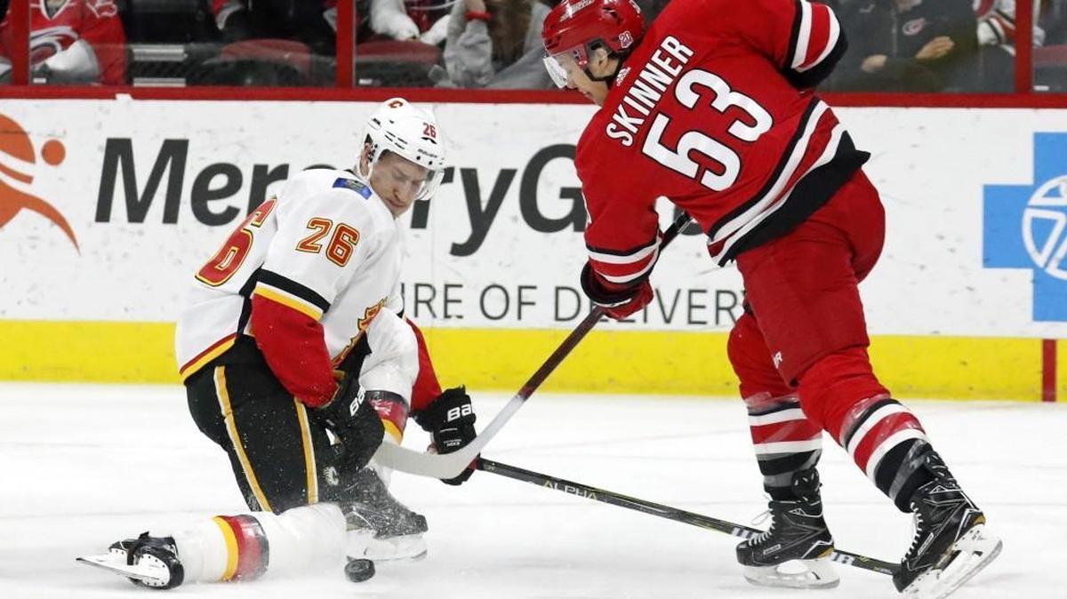 The Flames' Michael Stone (26) blocks a shot by the Canes' Jeff Skinner (53) during the first period of an NHL game played between the Carolina Hurricanes and the Calgary Flames at PNC Arena in Raleigh, N.C. on Jan. 14, 2018.