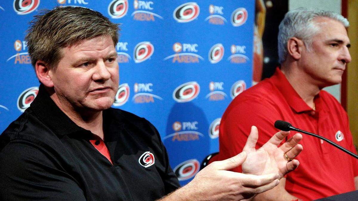 
Carolina Hurricanes head coach Bill Peters, left, and General Manager Ron Francis talk to reporters as they hold their end of the season press conference at PNC Arena in Raleigh on April15, 2015.
