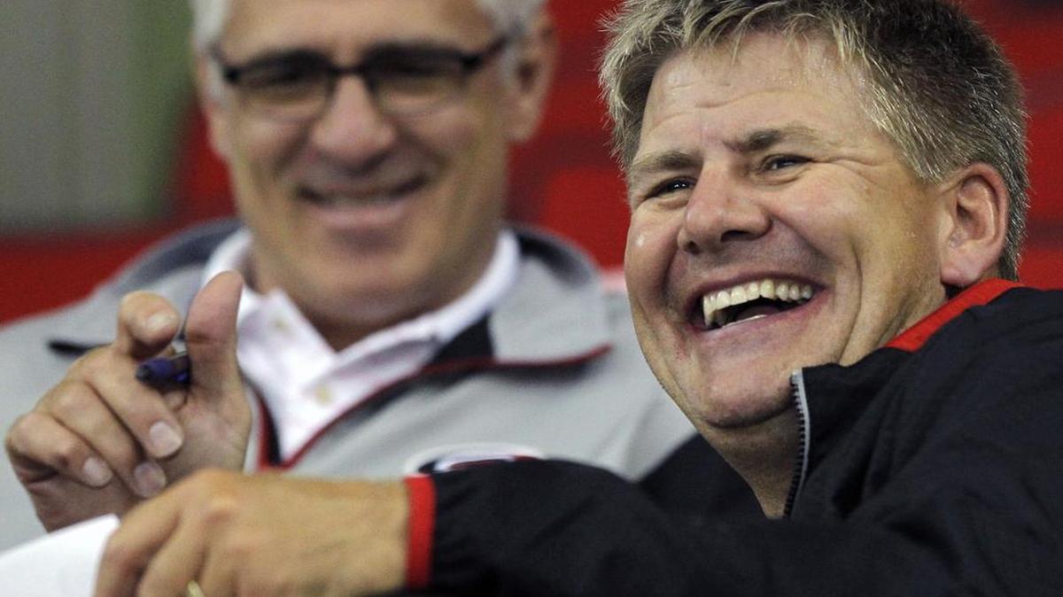Canes general manager Ron Francis, left, and head coach Bill Peters watch the young players during the Carolina Hurricanes development camp held at the PNC Arena in Raleigh, N.C. on July 24, 2014.