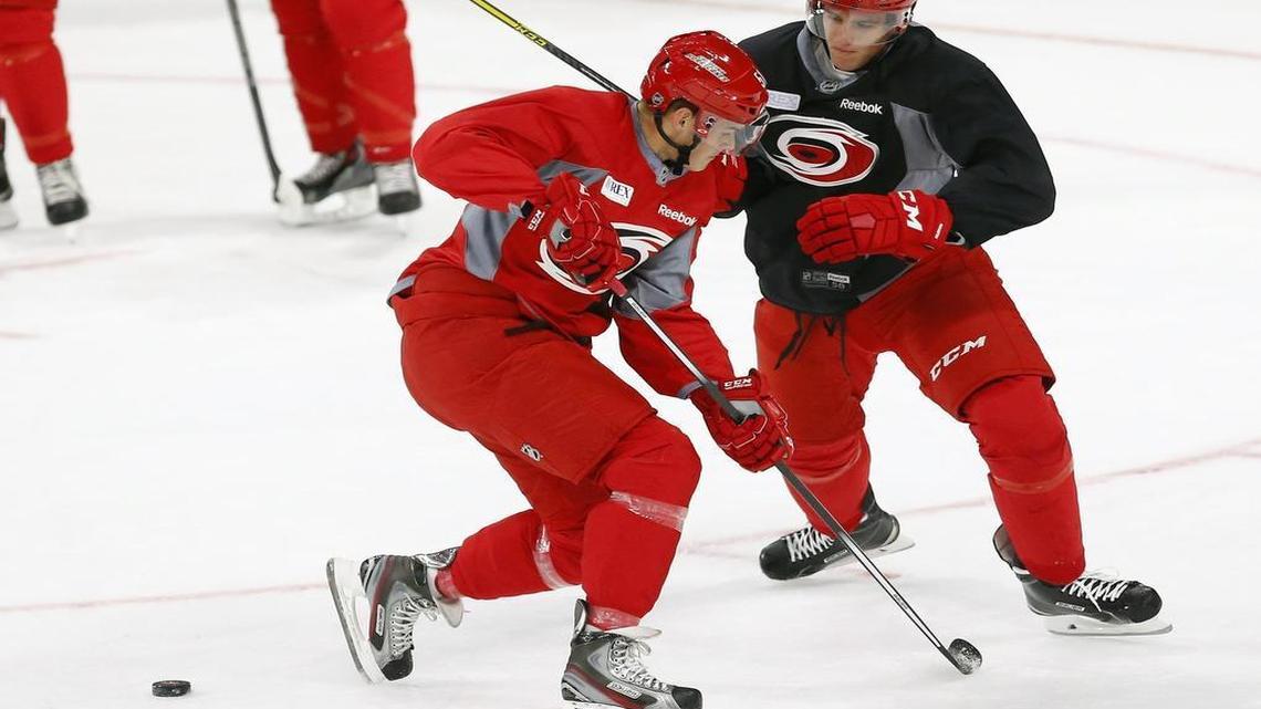 
 Noah Hanifin (5), right, knocks the puck loose as he defends against Gregory Hoffman (51) during the Carolina Hurricanes’ development camp for NHL prospects at PNC Arena in Raleigh on July 6, 2015. Hanifin was the Canes’ first-round pick in the NHL draft this year.
