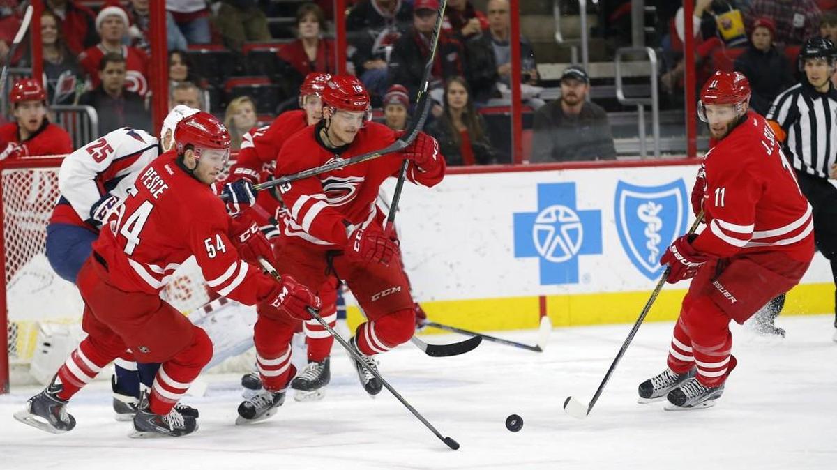 The Hurricanes’ Brett Pesce (54), Joakim Nordstrom (42), Andrej Nestrasil (15) and Jordan Staal (11) go for the puck against the Capitals on Dec. 21. The Canes’ “checking line” consists of Staal, Nestrasil and Nordstrom.