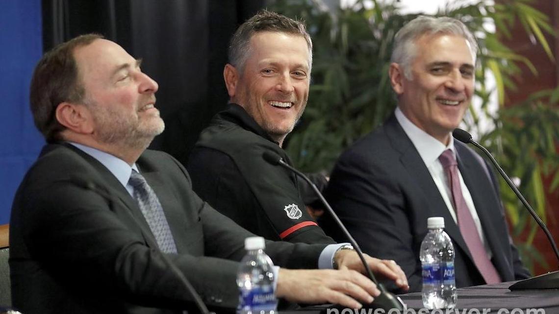 NHL commissioner Gary Bettman, left, Thomas Dundon, new Hurricanes majority owner, center, and Canes' general manager Ron Francis laugh.
