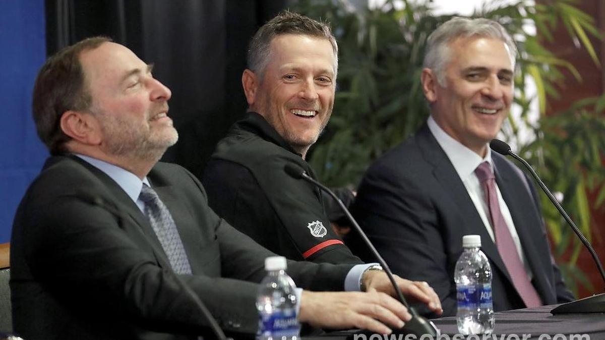 NHL commissioner Gary Bettman, left, Thomas Dundon, new Hurricanes majority owner, center, and Canes' general manager Ron Francis laugh.