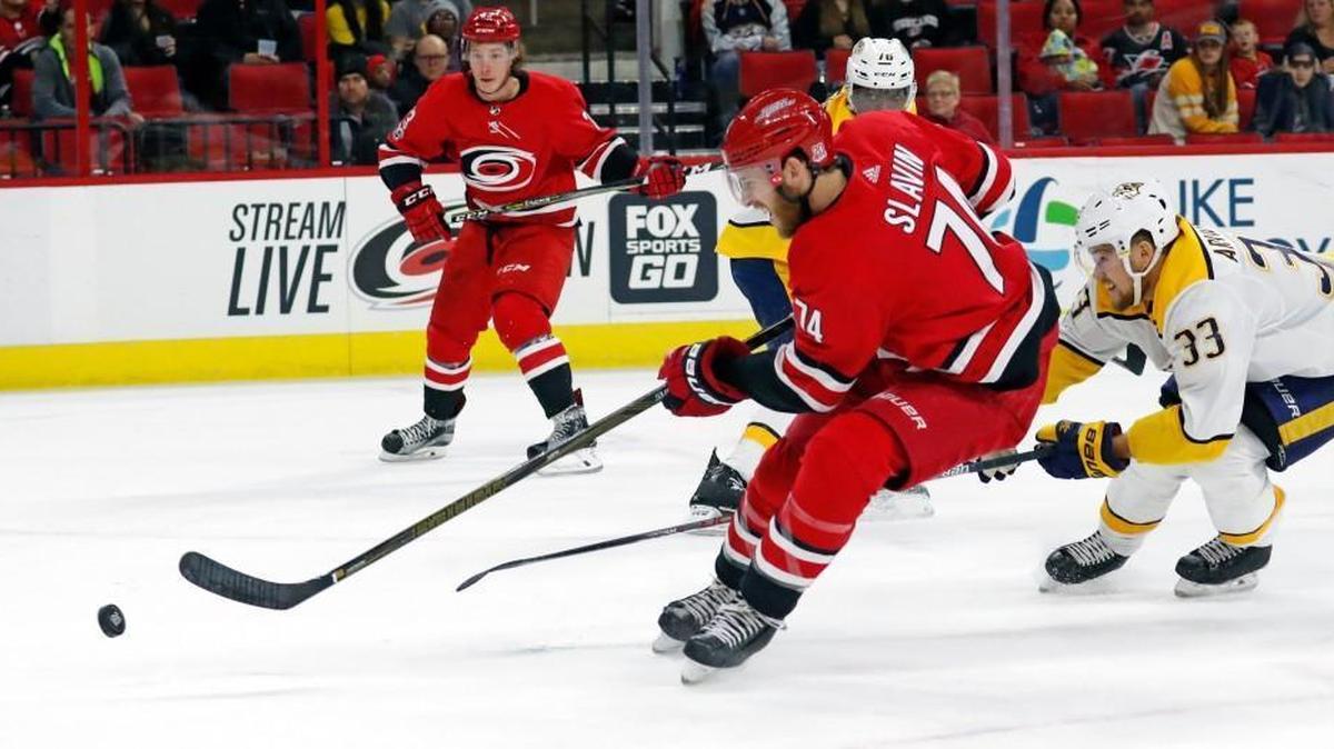 The Canes' Jaccob Slavin (74) drives against the Predators' Viktor Arvidsson (33) during the first period of an NHL game played between the Carolina Hurricanes and the Nashville Predators at PNC Arena in Raleigh, N.C. on Nov. 26, 2017. The Canes beat the Predators 4-3 in a shootout.