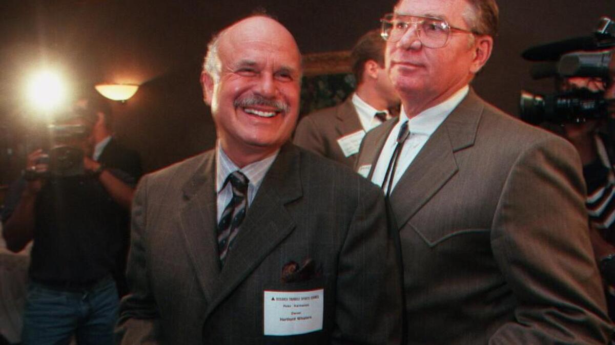Hartford Whalers owner Peter Karmanos, left, came to Raleigh Tuesday to talk about bringing the team here. At right is Steve Stroud. staff/Chris Seward