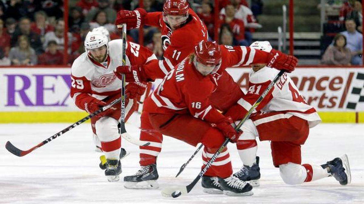 
The Canes’ Jordan Staal (11) and Elias Lindholm (16) battle the Red Wings' Landon Ferraro (29) and Luke Glendening (41) for the puck during the first period at PNC Arena in Raleigh.
