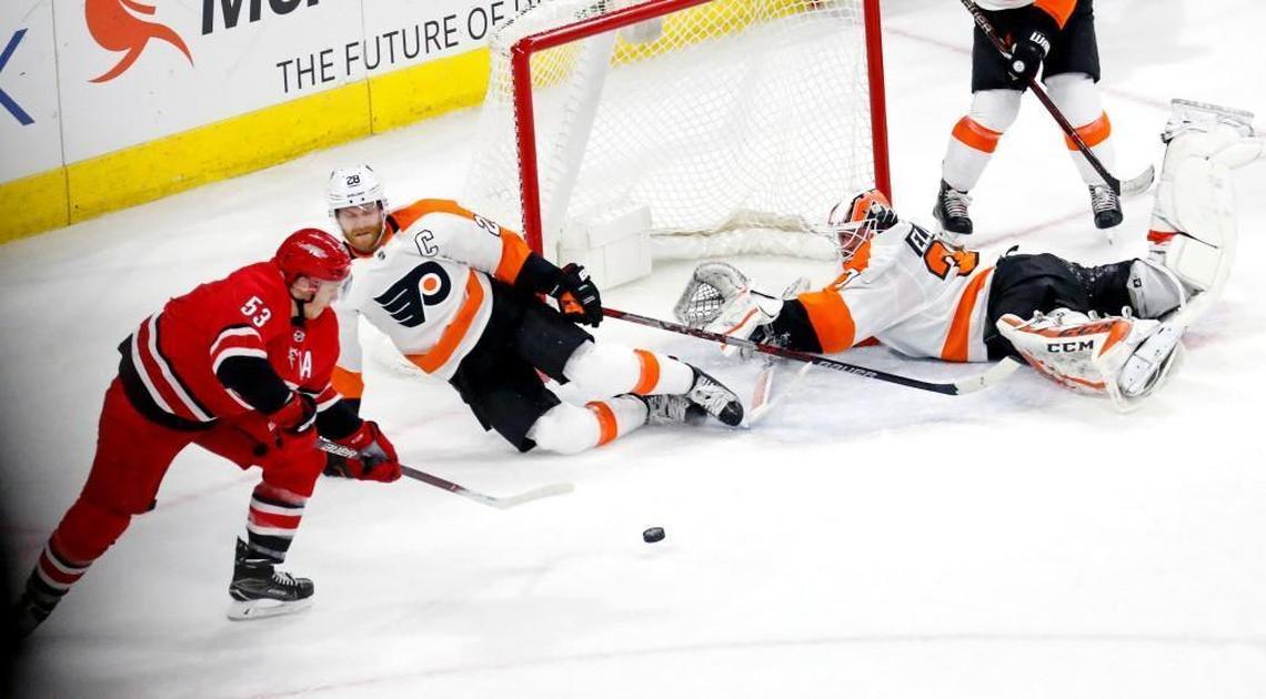 The Canes' Jeff Skinner (53) has his shot stopped by the Flyers' Claude Giroux (28) and the Flyers goalie Brian Elliott (37) during the overtime period at PNC Arena on Feb. 6, 2018. The Flyers beat the Canes 2-1 in overtime.
