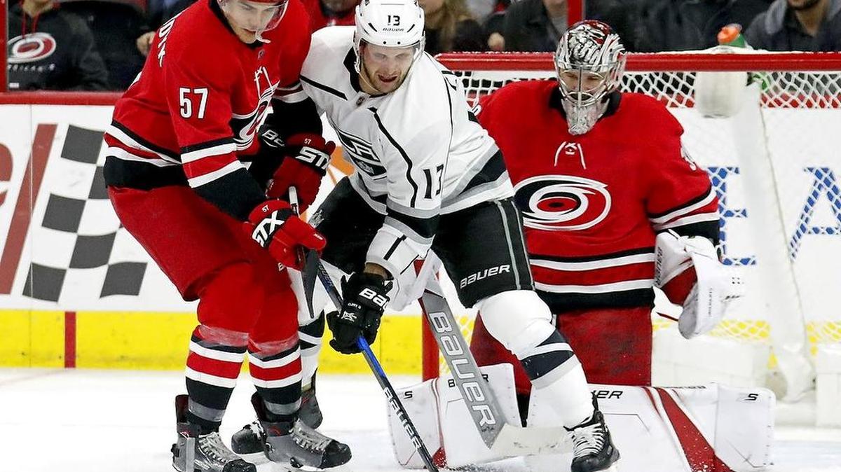 The Canes' Trevor van Riemsdyk (57) and Cam Ward (30) defend against the Kings' Kyle Clifford (13) in a 2018 game.