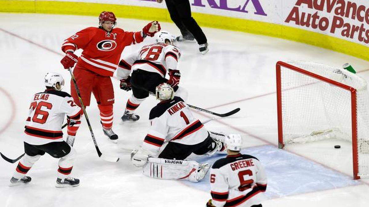 
The Canes’ Eric Staal (12) celebrates after he scored what proved to be the game winning goal against the Devils’ Patrik Elias (26), Damon Severson (28), Keith Kinkaid (1) and Andy Greene (6) during the third period of an NHL game played between the Carolina Hurricanes and the New Jersey Devils at PNC Arena in Raleigh, N.C. on March 28, 2015. The Canes beat the Devils 3-1.
