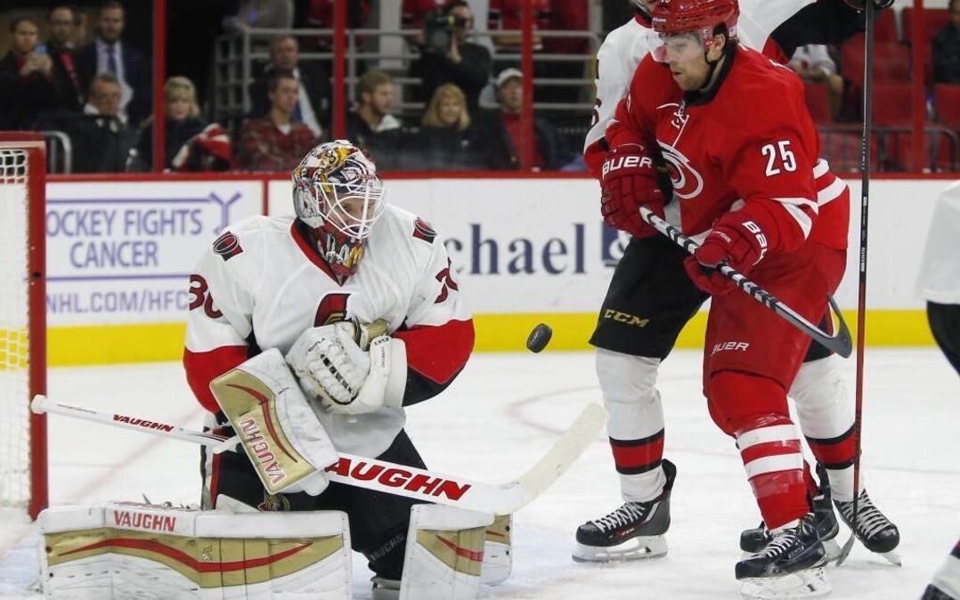 The Canes’ Chris Terry (25) tries to score against the Ottawa Senators' Andrew Hammond (30) and Bobby Ryan (6) during the first period at PNC Arena in Raleigh.